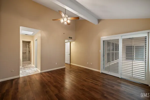 a view of a room with wooden floor