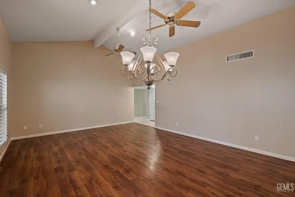 a view of a chandelier fan and wooden floor