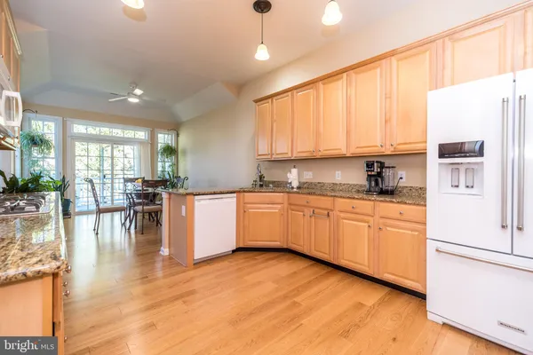 a kitchen with granite countertop white cabinets stainless steel appliances and sink