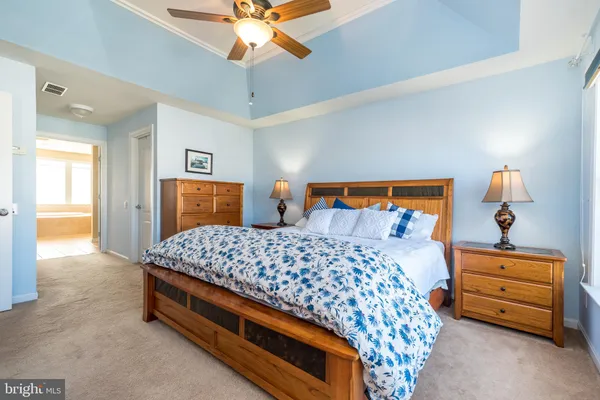 a spacious bedroom with a bed and a window