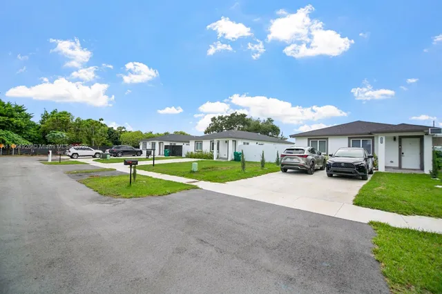 a view of a house with a swimming pool and a yard