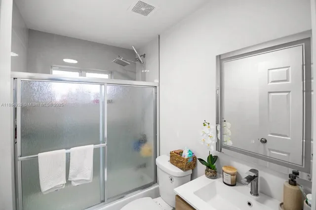 a bathroom with a shower and a sink