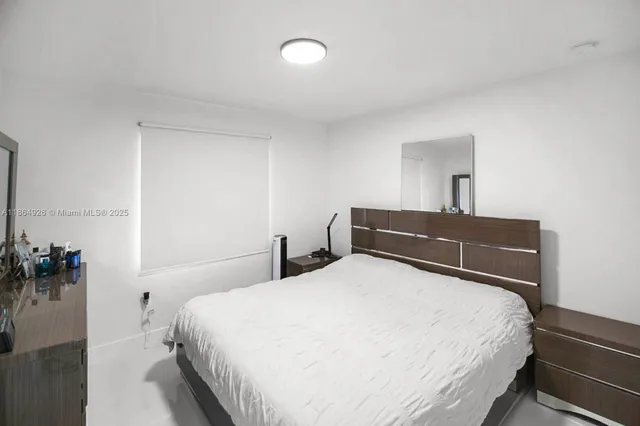 a bedroom with a bed and a potted plant