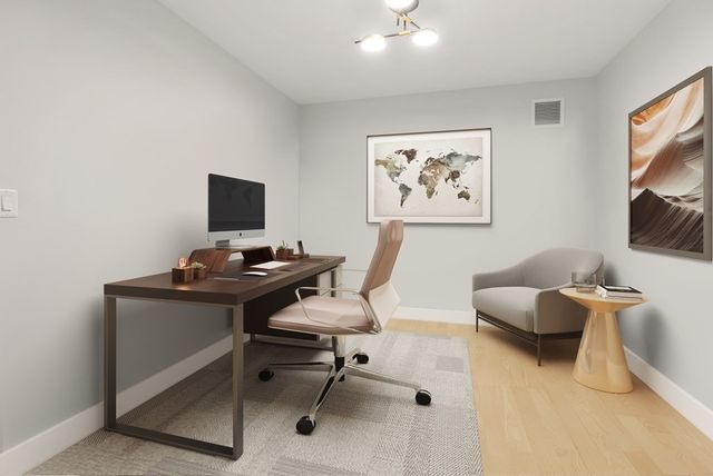 a view of a workspace with furniture and a window
