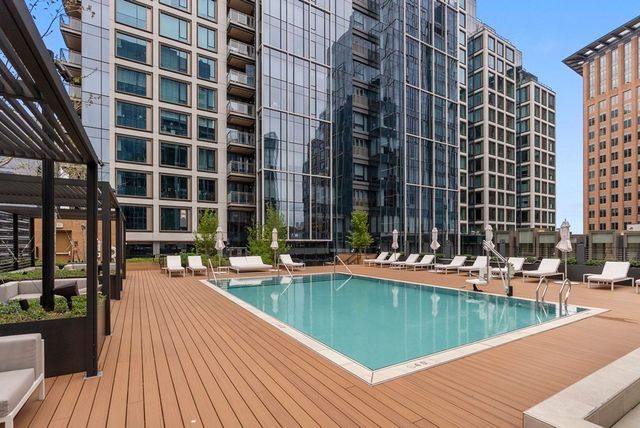 a view of a swimming pool with outdoor seating