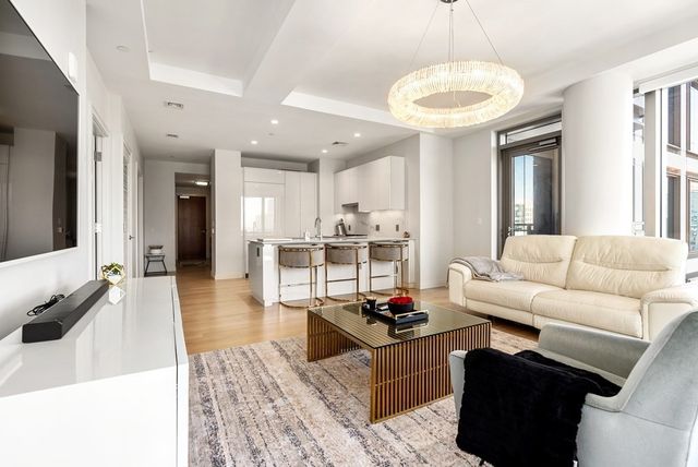 a living room with furniture and a chandelier