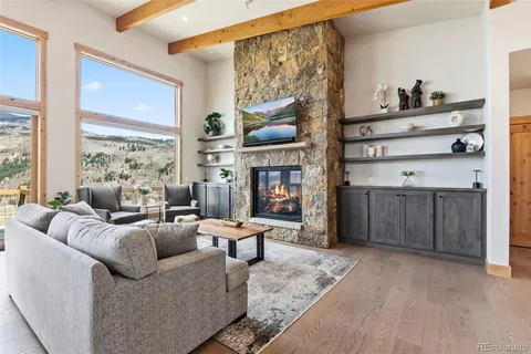 a living room with furniture cabinets and a window