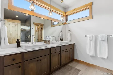 a bathroom with a double vanity sink and a mirror