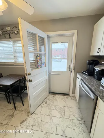 a view of a kitchen with a table and a window