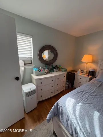a bedroom with a bed and flat screen tv