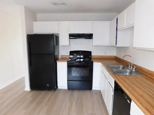 a kitchen with a refrigerator and a sink