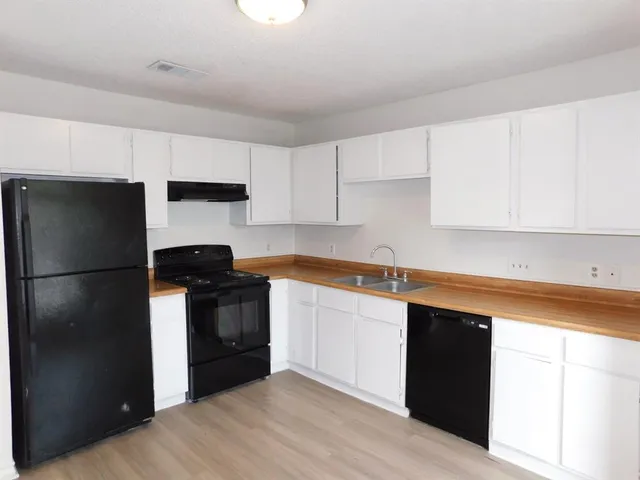 a kitchen with a sink and a refrigerator