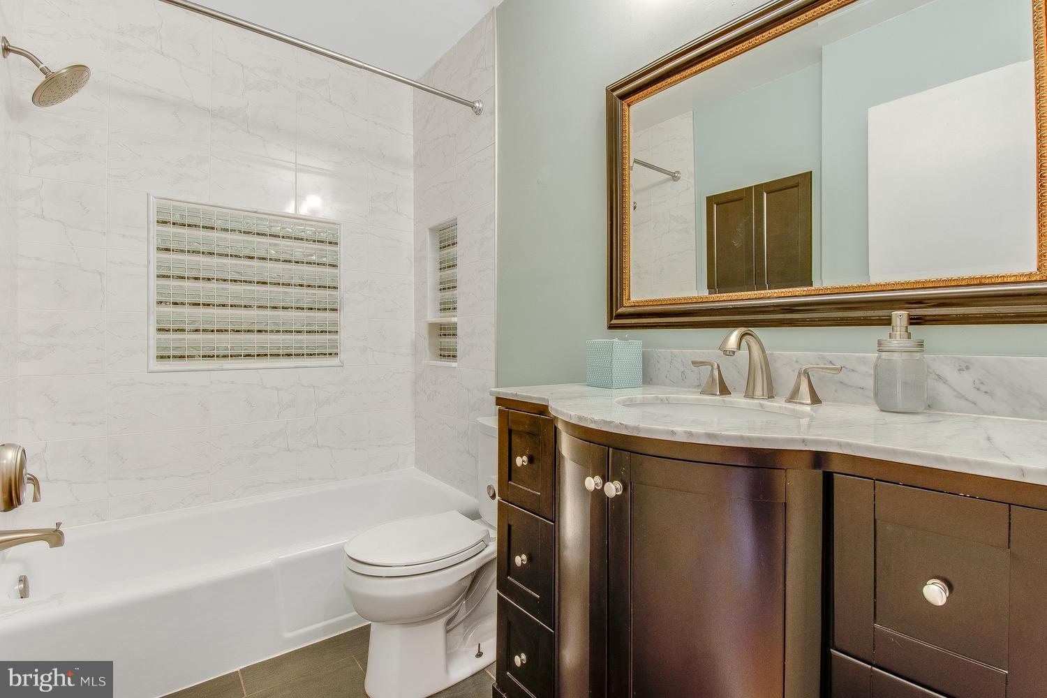 18908 Bloomfield Road Olney, MD 20832 - Photo 17 of 30 a bathroom with a sink a toilet and shower