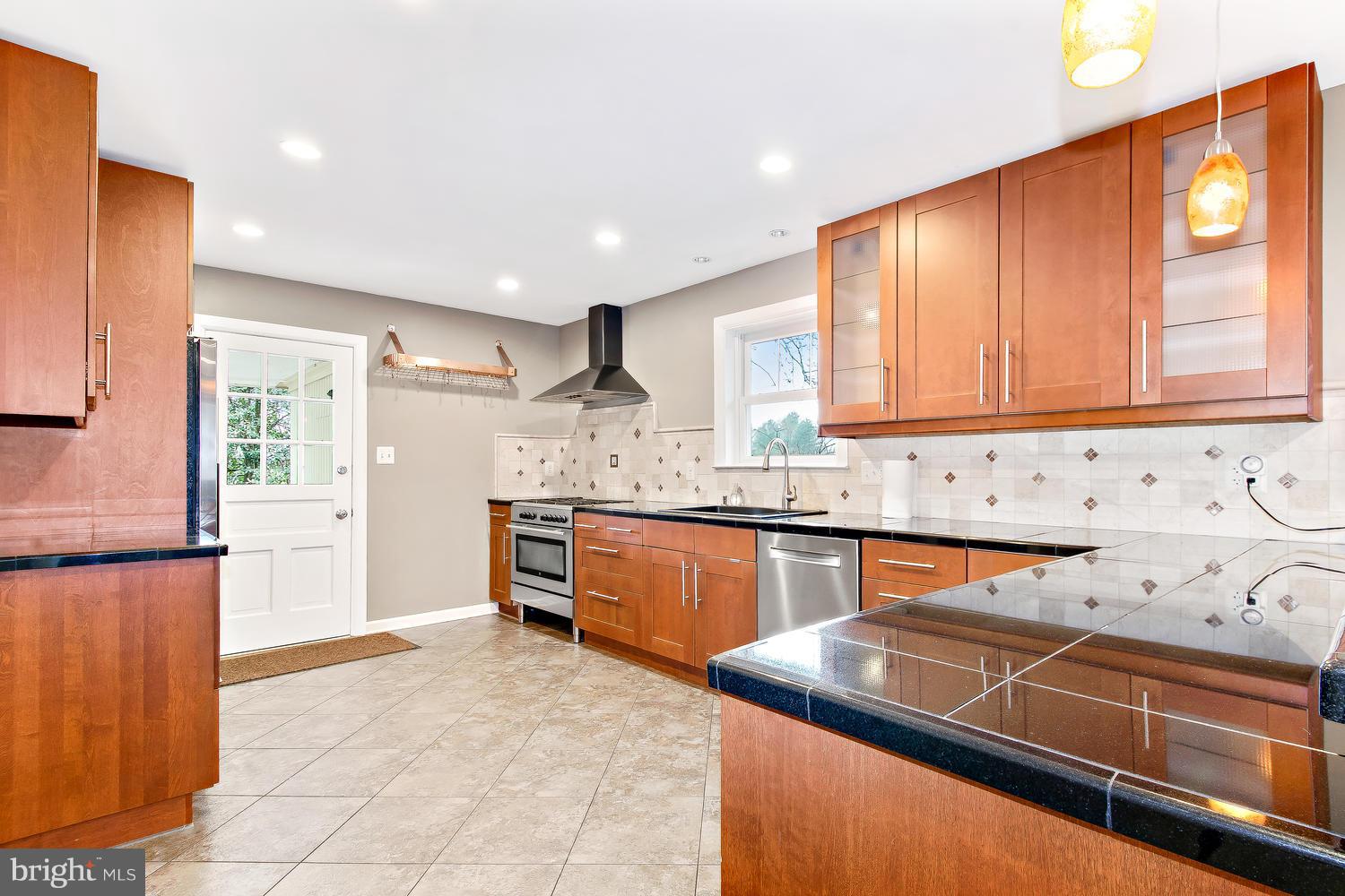 18908 Bloomfield Road Olney, MD 20832 - Photo 3 of 30 a kitchen with granite countertop a sink and cabinets