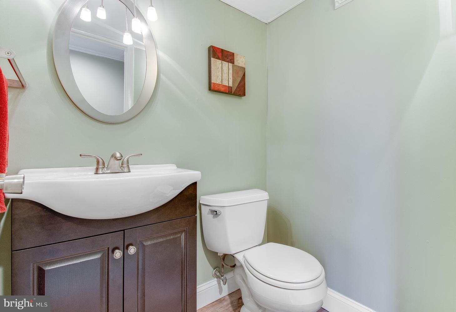 18908 Bloomfield Road Olney, MD 20832 - Photo 23 of 30 a bathroom with a toilet a sink and mirror