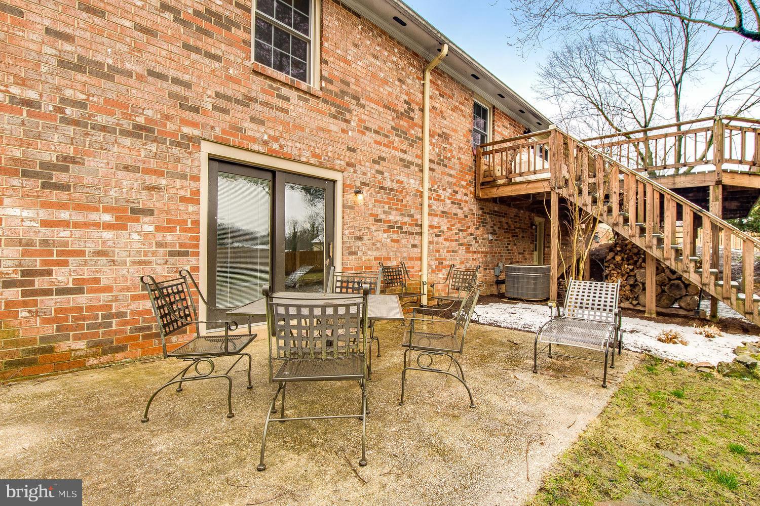 18908 Bloomfield Road Olney, MD 20832 - Photo 27 of 30 a view of a patio with table and chairs and potted plants