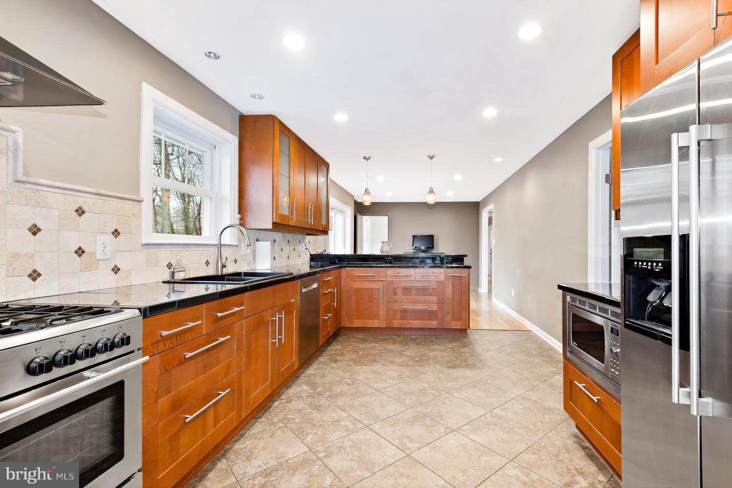 18908 Bloomfield Road Olney, MD 20832 - Photo 4 of 30 a large kitchen with stainless steel appliances granite countertop a stove a sink and a refrigerator