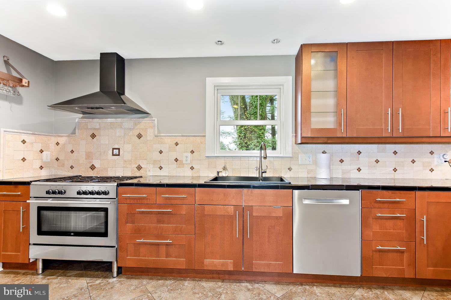 18908 Bloomfield Road Olney, MD 20832 - Photo 5 of 30 a kitchen with granite countertop a stove sink and cabinets