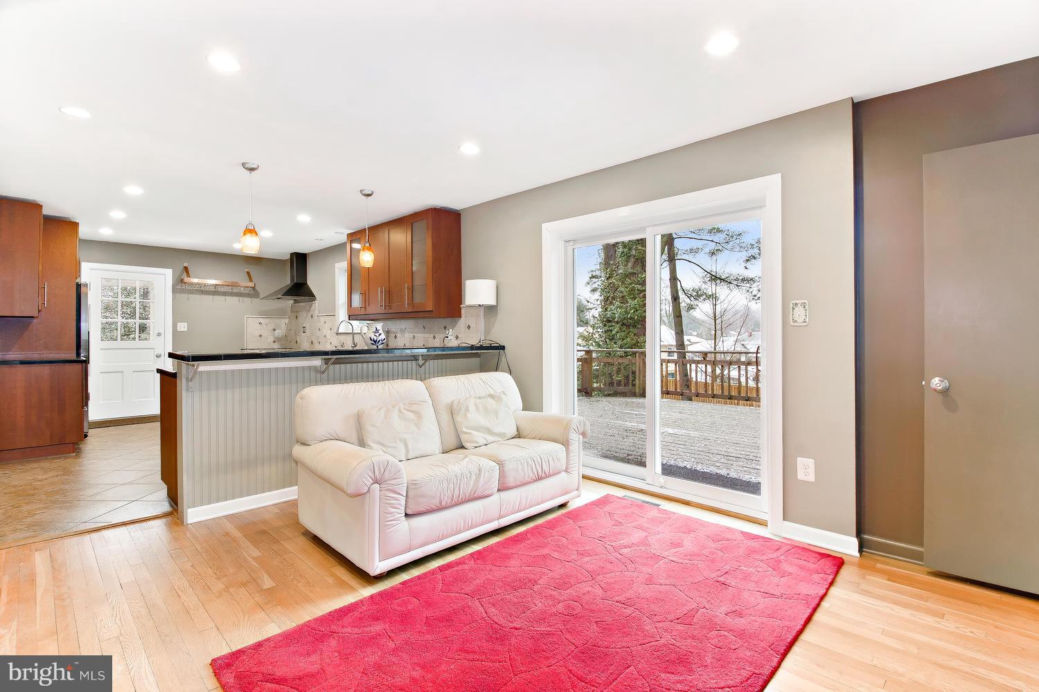 18908 Bloomfield Road Olney, MD 20832 - Photo 6 of 30 a living room with kitchen island furniture and a wooden floor