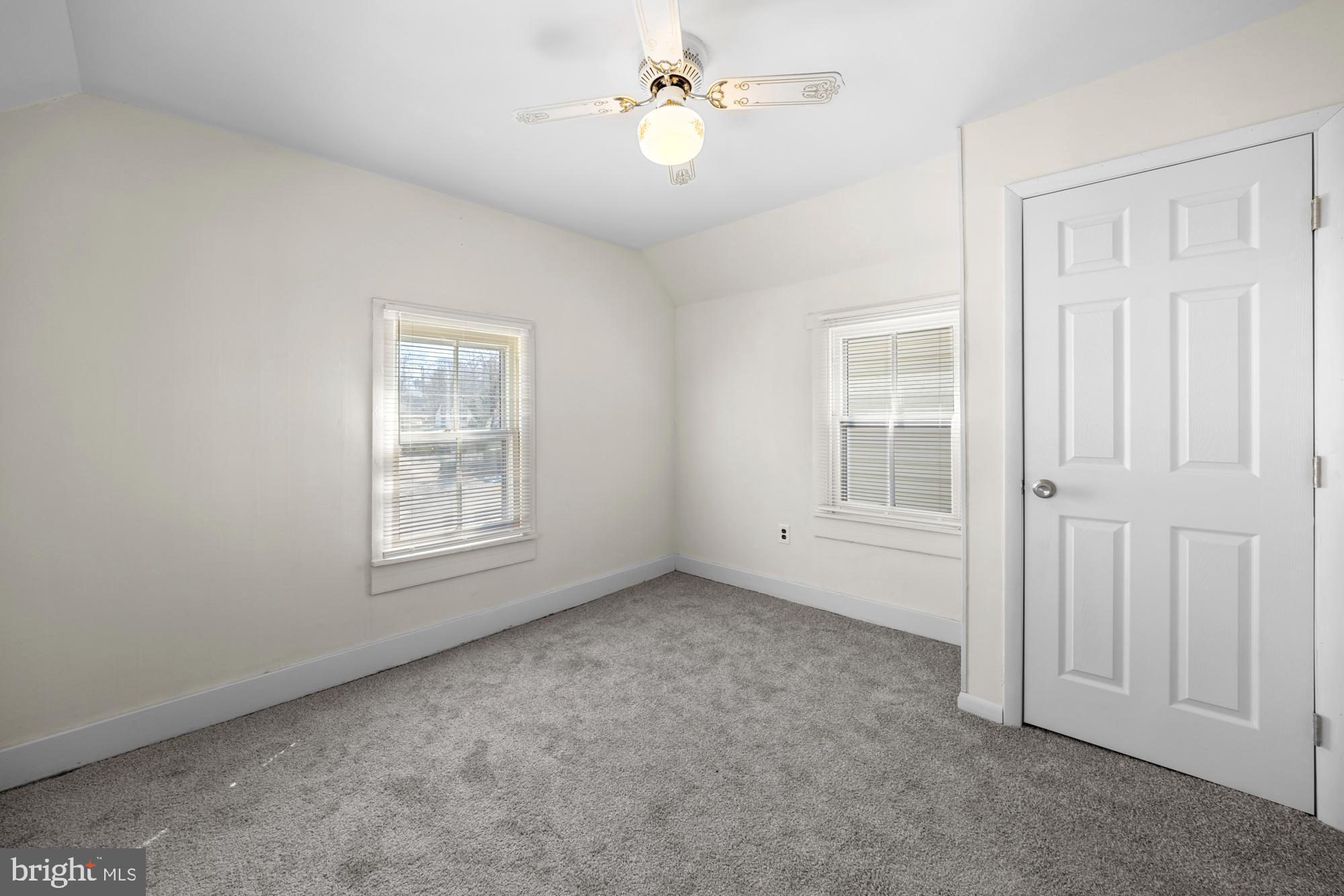 131 North Avenue Pitman, NJ 08071 - Photo 14 of 17 an empty room with windows and ceiling fan