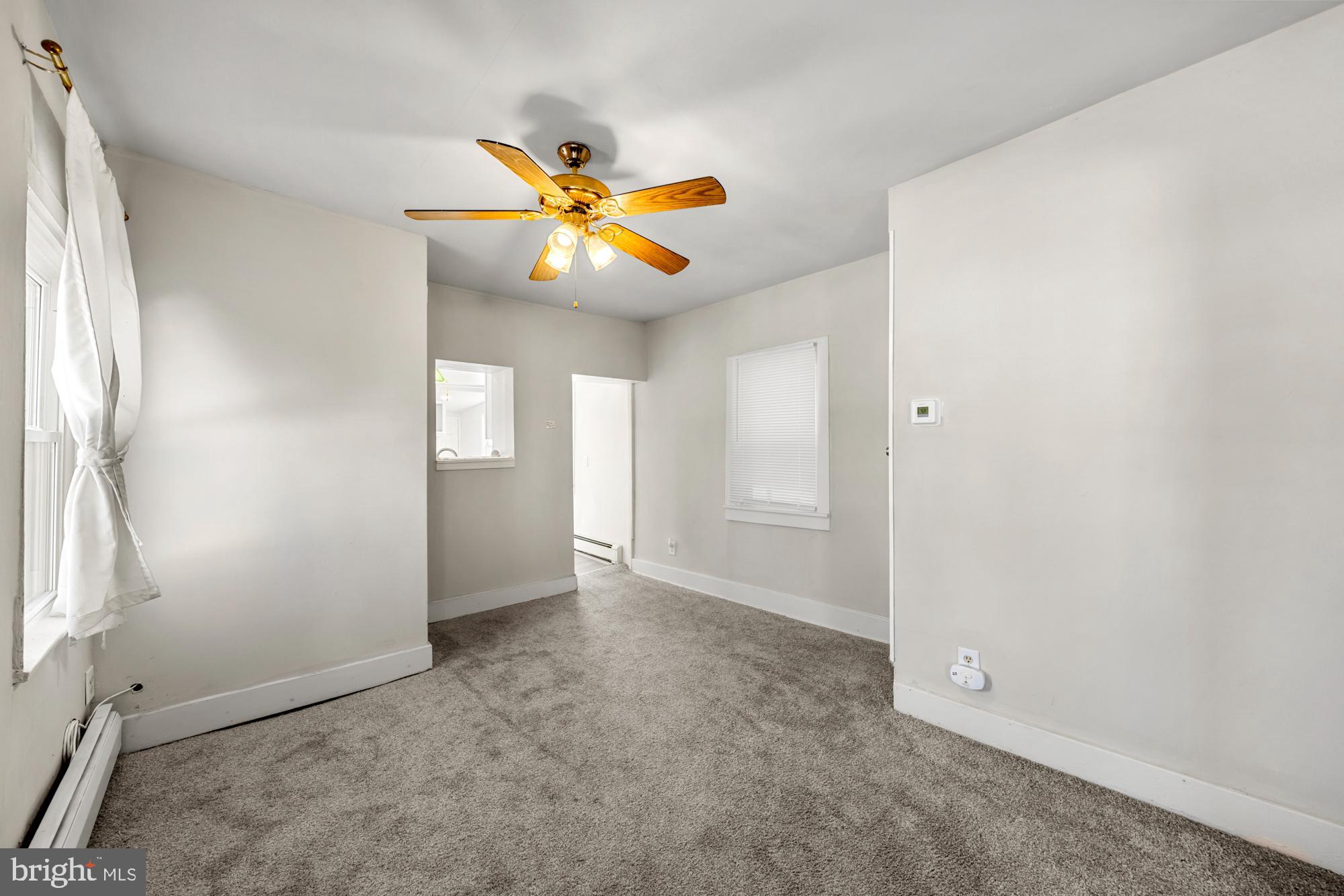 131 North Avenue Pitman, NJ 08071 - Photo 8 of 17 an empty room with windows and fan