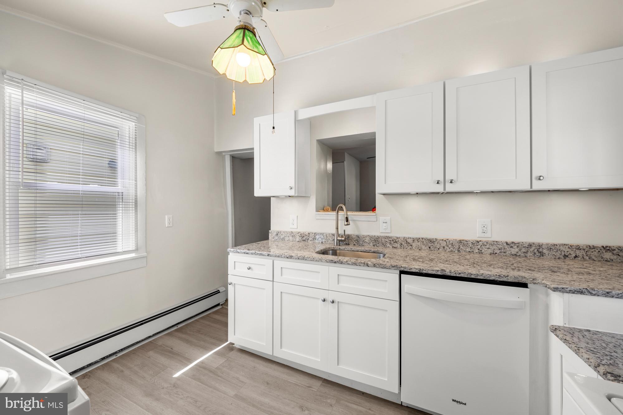 131 North Avenue Pitman, NJ 08071 - Photo 10 of 17 a kitchen with granite countertop a sink stainless steel appliances and cabinets
