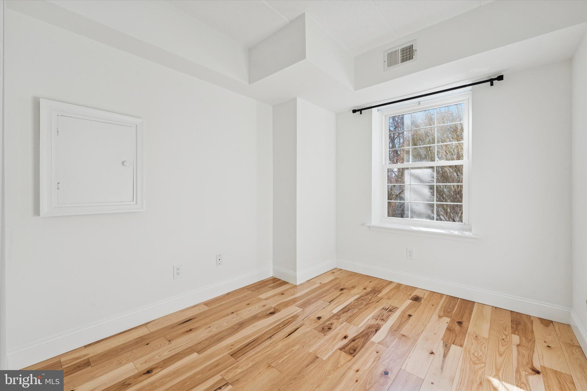 612 Washington Place, Unit 12 Chesterbrook, PA 19087 - Photo 11 of 15 a view of a room with wooden floor and white walls