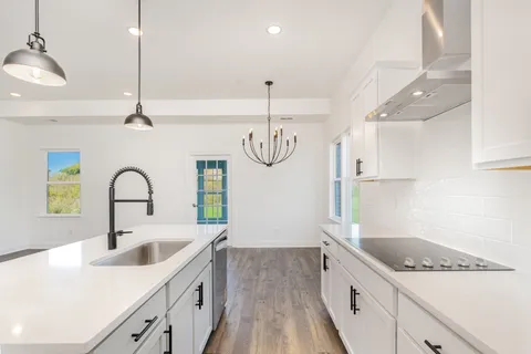 a kitchen with a sink stove and cabinets