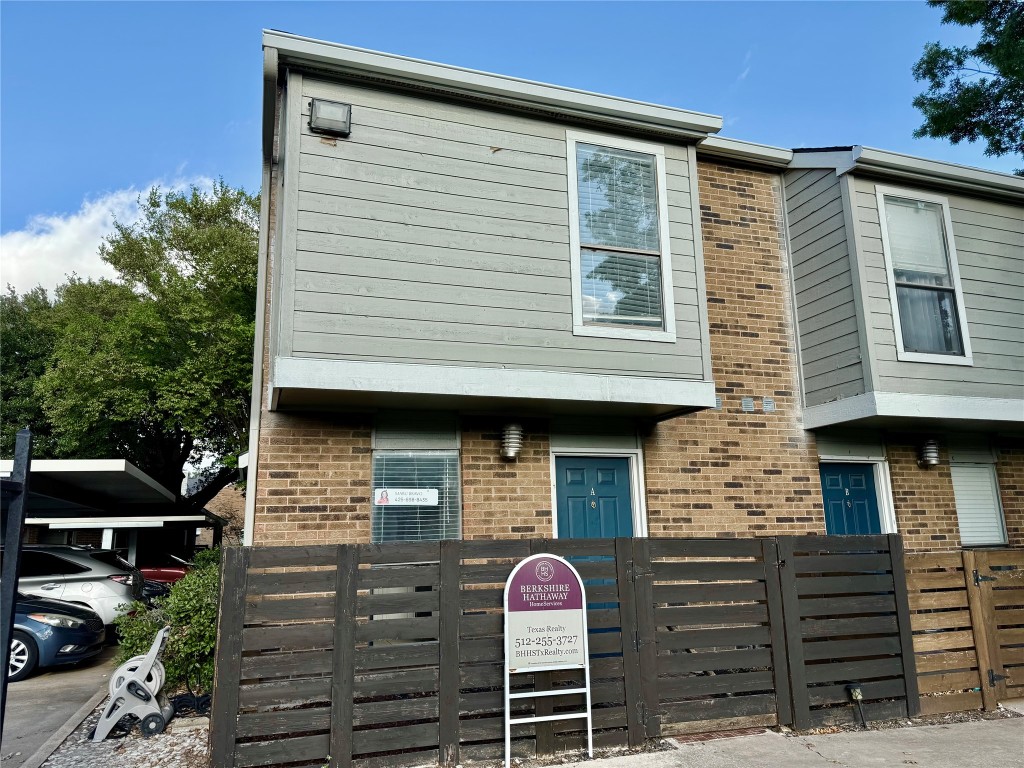 2018 West Rundberg Lane, Unit 6A Austin, TX 78758 - Photo 2 of 16 a front view of a house with wooden fence
