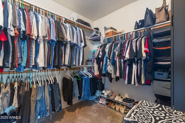 a bedroom with a bed and a ceiling fan