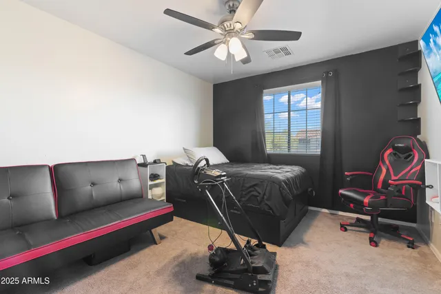 a bedroom with a bed and a desk