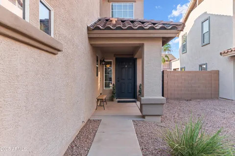 a front view of a house with garden and patio