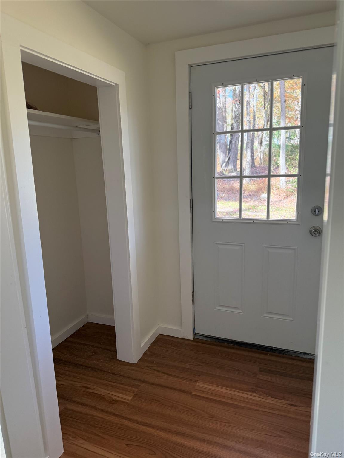 553 Cold Spring Road Monticello, NY 12701 - Photo 7 of 15 a view of an empty room with wooden floor and a window