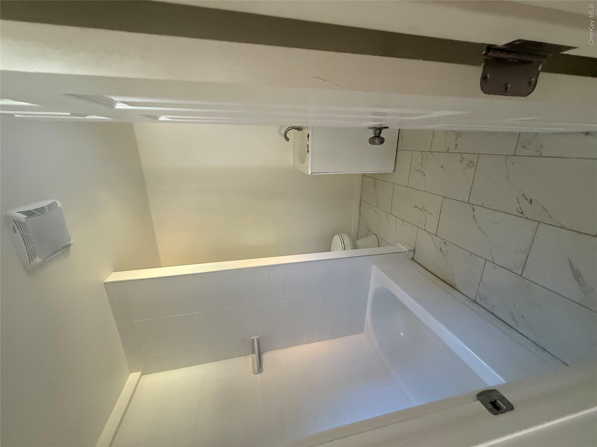 553 Cold Spring Road Monticello, NY 12701 - Photo 9 of 15 a bathroom with a bathtub and toilet