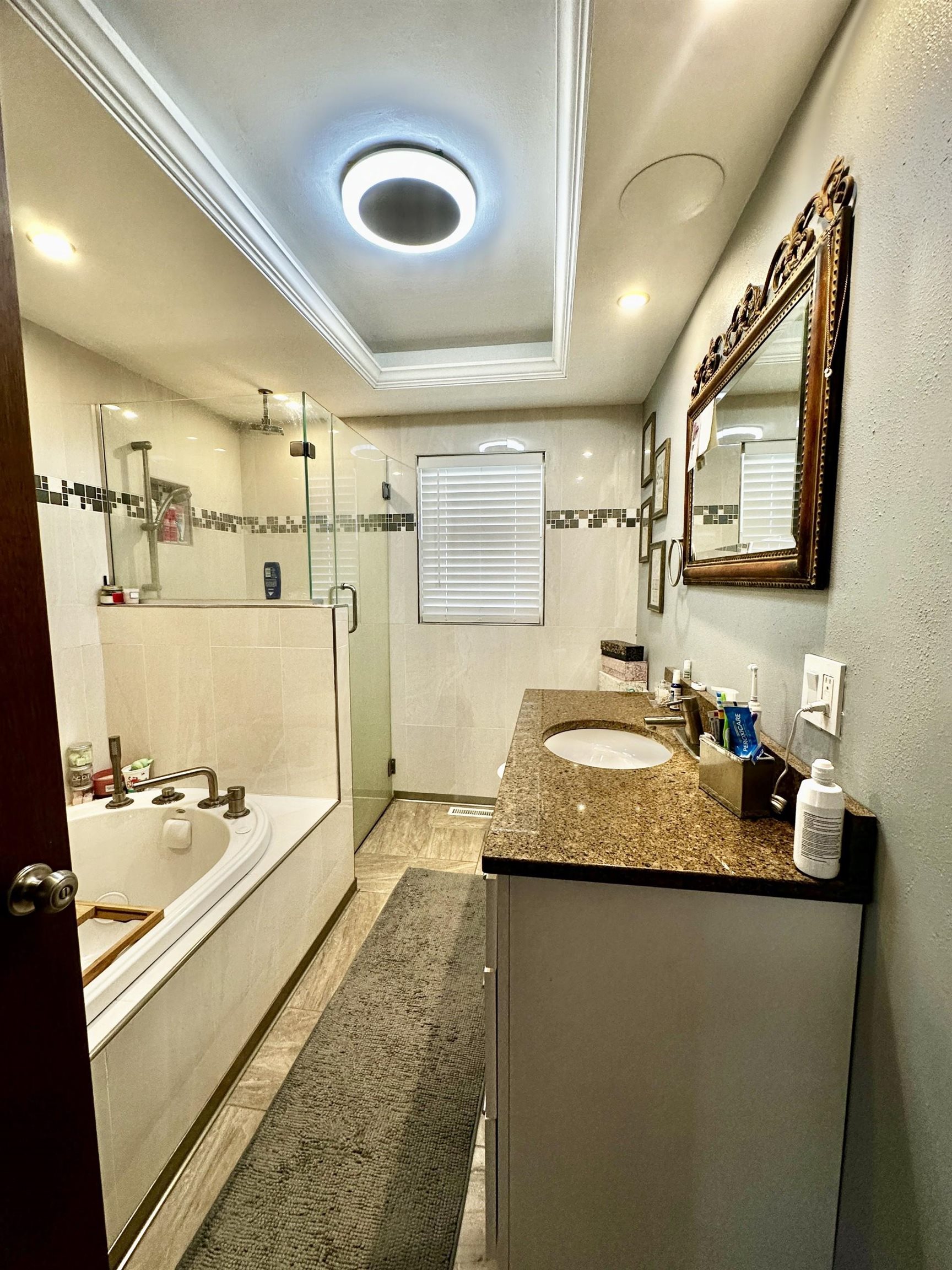 919 3rd Avenue Fulton, IL 61252 - Photo 18 of 24 a bathroom with a granite countertop sink a mirror and shower
