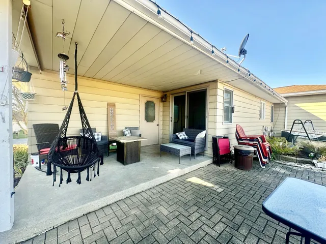 a view of a patio with table and chairs