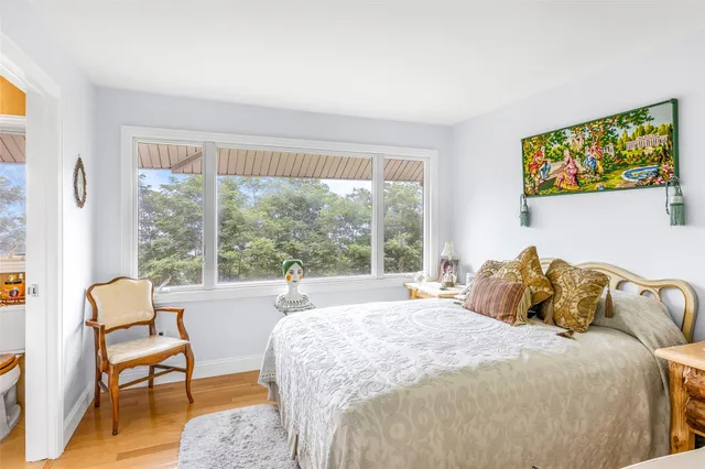 a bedroom with a bed and a large window