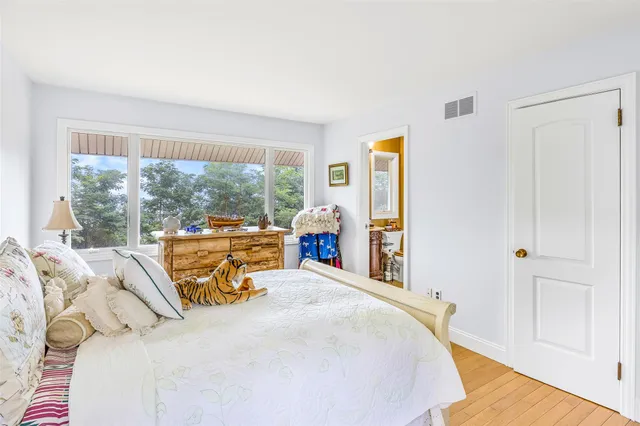 a bed sitting in a bedroom next to a window