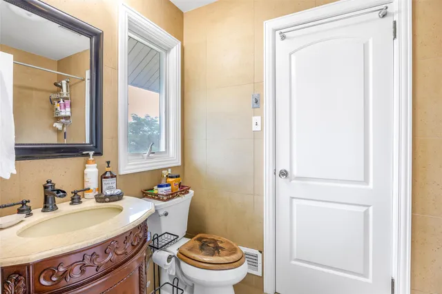 a bathroom with a sink a toilet and a mirror