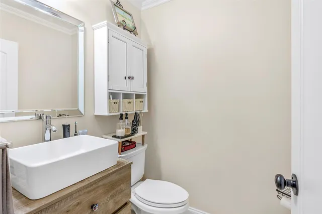 a bathroom with a sink a toilet a mirror and shower