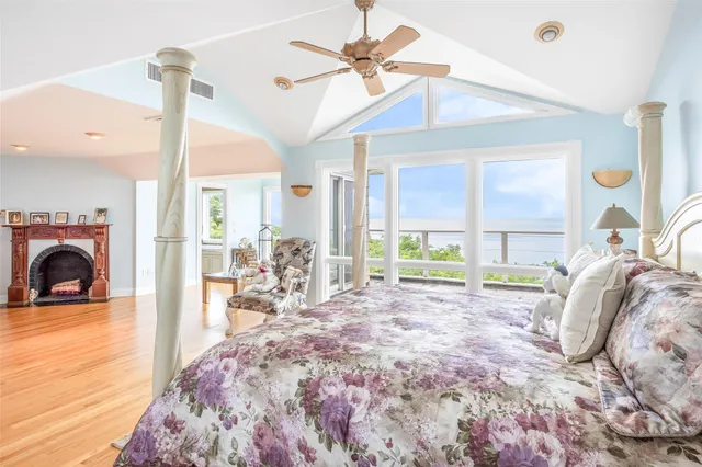a view of a bedroom with furniture window and a ceiling fan
