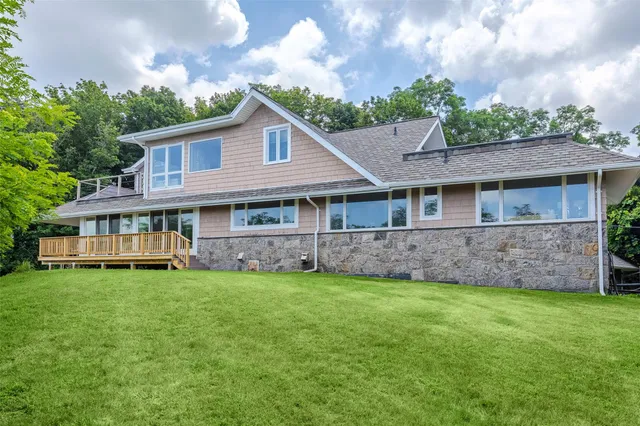 a view of a house with a yard and sitting area