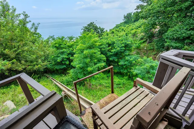 a view of a two chairs in the balcony