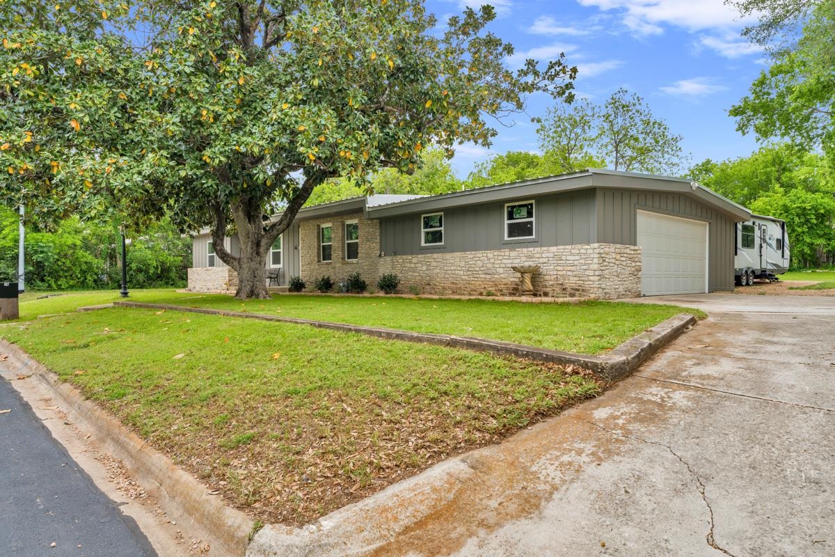 407 East Kerr Street Burnet, TX 78611 - Photo 6 of 21 a front view of a house with garden