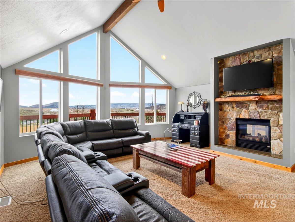11714 Chukar Ridge Lane Horseshoe Bend, ID 83629 - Photo 14 of 50 Living area featuring a stone fireplace, carpet flooring, and a mountain view