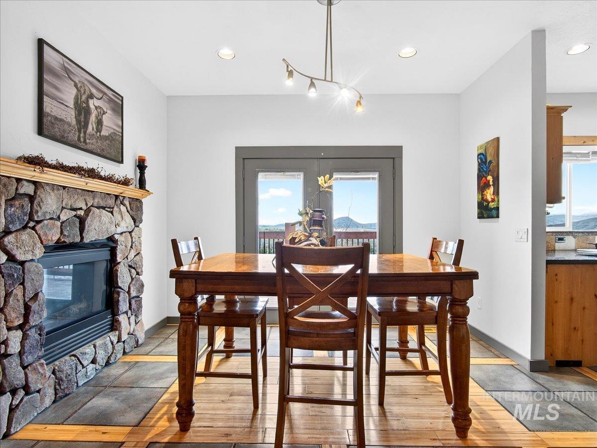 11714 Chukar Ridge Lane Horseshoe Bend, ID 83629 - Photo 22 of 50 Dining space with recessed lighting, a stone fireplace, and light wood-type flooring