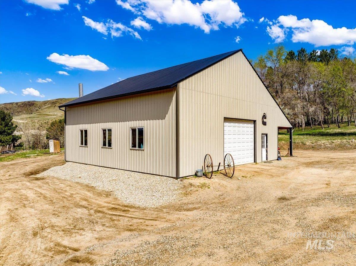 11714 Chukar Ridge Lane Horseshoe Bend, ID 83629 - Photo 45 of 50 View of side of property with a garage, an outdoor structure, and driveway