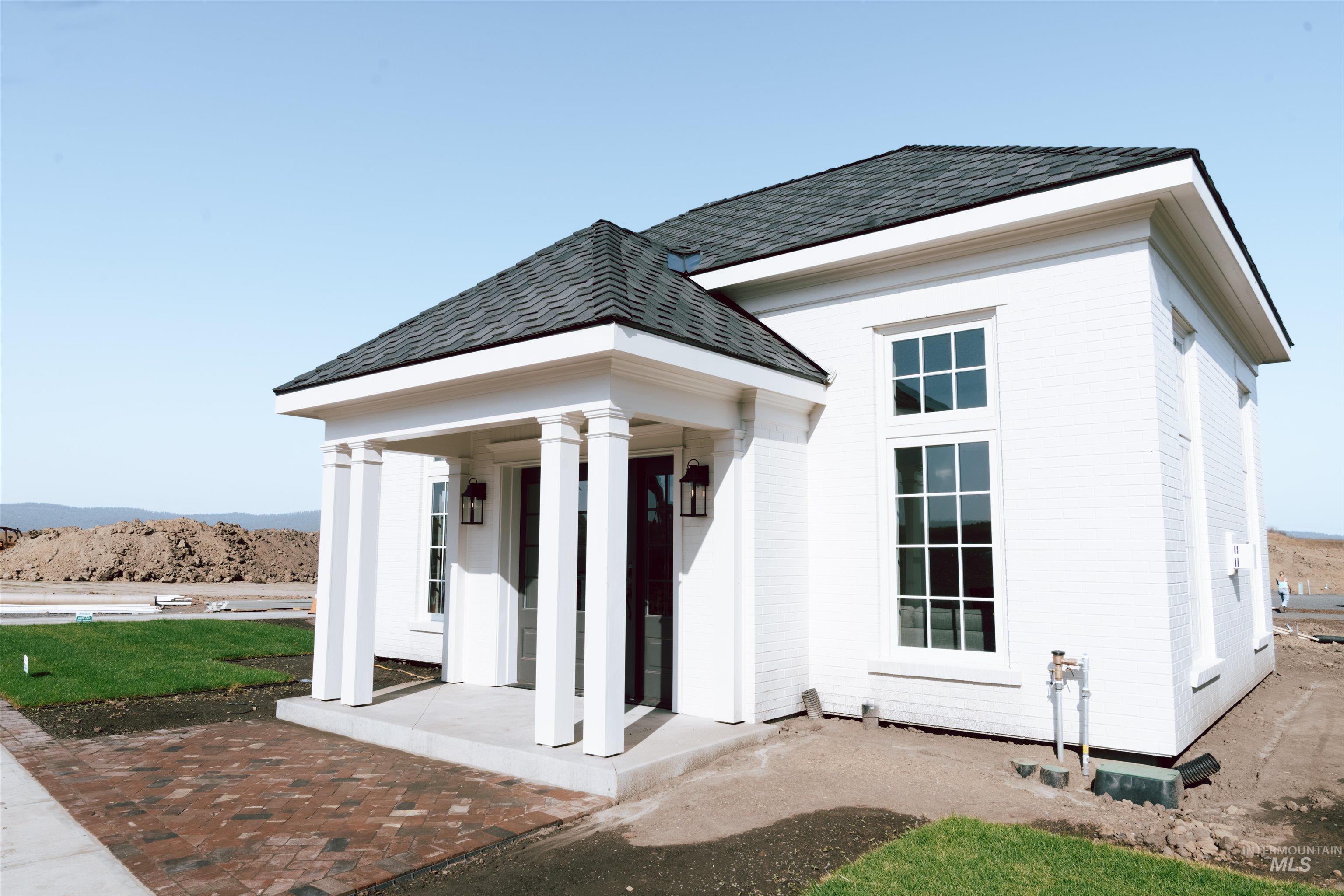 1354 Slonaker, Unit BISHOP Moscow, ID 83843 - Photo 28 of 29 Back of house featuring roof with shingles and a porch
