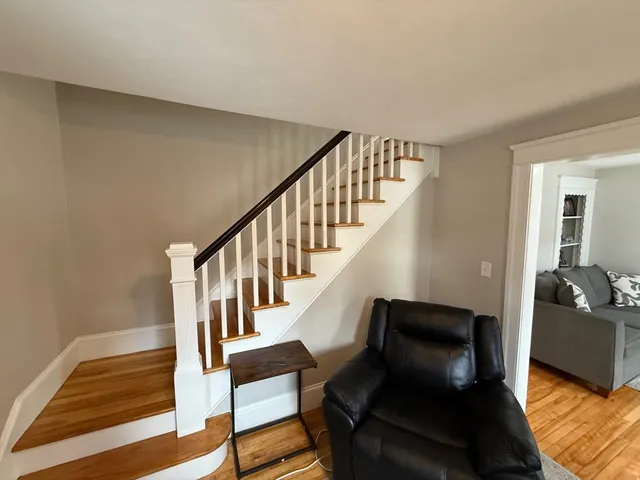 a view of entryway and hall with wooden floor