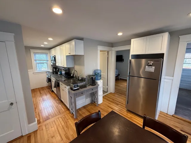 a kitchen with stainless steel appliances granite countertop a refrigerator stove top oven and sink